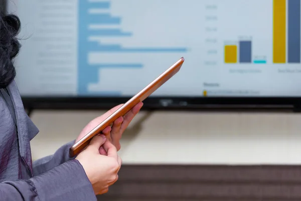 Businesswoman with a tablet discussing business on the workplace