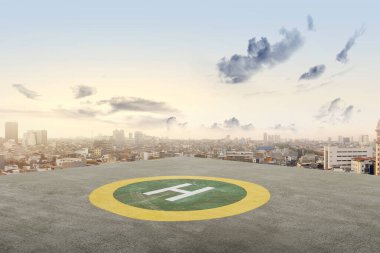 The helipad in the rooftop of the building with cityscapes background clipart