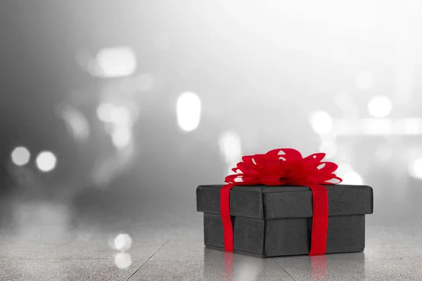 Gift Box Red Ribbon Blurred Light Background Black Friday Concept — Stock Photo, Image