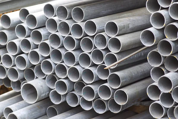 Metal profile pipe of round section in packs at the warehouse of metal products — Stock Photo, Image