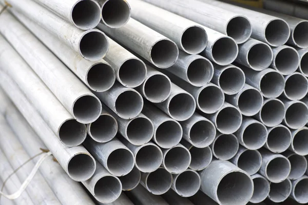 Metal profile pipe of round section in packs at the warehouse of metal products — Stock Photo, Image