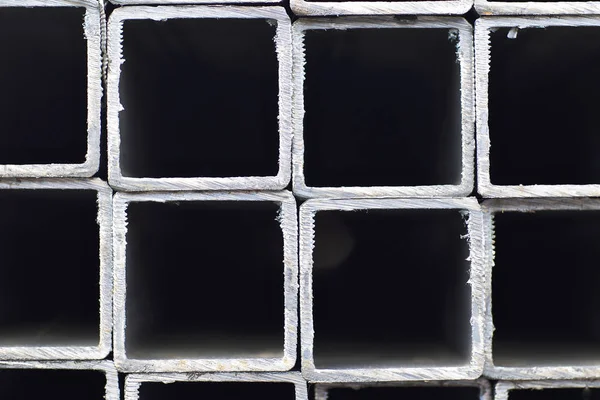 stock image Metal profile pipe of rectangular cross section in packs at the warehouse of metal products