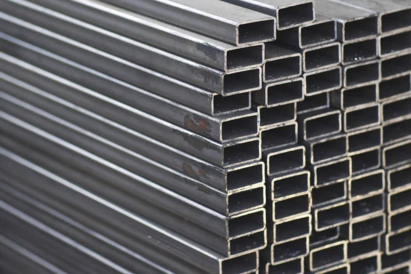 Metal profile pipe of rectangular cross section in packs at the warehouse of metal products — Stock Photo, Image