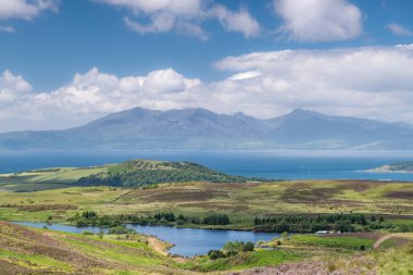 The magnificent Isle of Arran looking through a June heat haze that is sitting on top of the water clipart