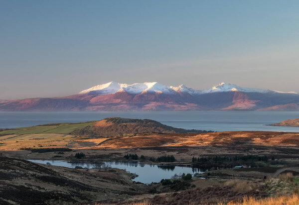 Early in the morning the light rises causing magical light and shadows accross Dalry Moor and onto Arran accross the Clyde estury.
