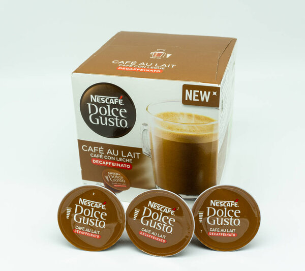 Largs, Scotland, UK - August 14, 2018: Three small refills and cardboard exterior box for the Nescafe' Dolce Gusto Coffee Machines on a white backgropund. Fast becomong popular in home prepared caffe drinks. Taken against a white background.