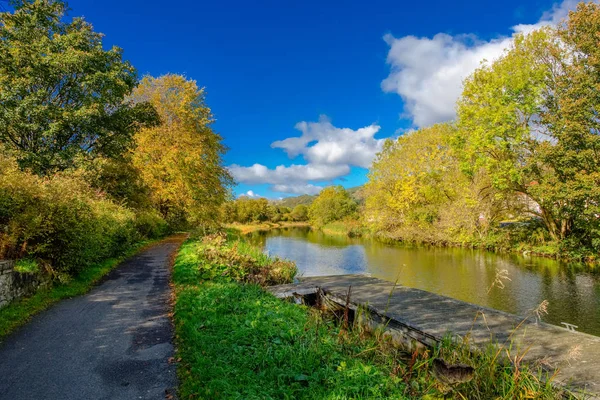 stock image Looking  along the old Forth & Clyde Canal in Autumn with the autumn colours on the trees and river banks.