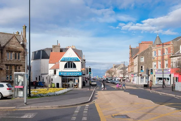 stock image Largs, Scotland, UK - October 31, 2018: Main Street largs looking West toward the Pierhead with people using the pedestrian crossing during a quiet day in the town centre.