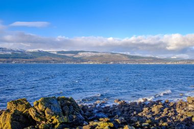 Dunoon and the Argyle Hills looking over the Holy Loch from Gourock with the first signs of Snow on the hills in December clipart