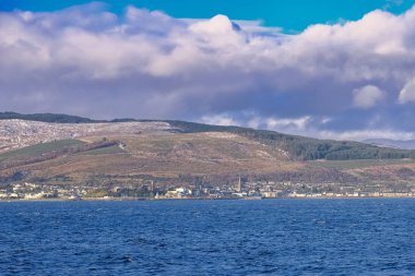 Dunoon and the Argyle Hills looking over the Holy Loch from Gourock with the first signs of Snow on the hills in December clipart