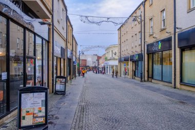 Kilmarnock, Scotland, UK - December 10, 2018: Burns Precinct pedestrian area in the Scottish town centre of Kilmarnock with empty shops being an area of high unemployment and very little industry. clipart