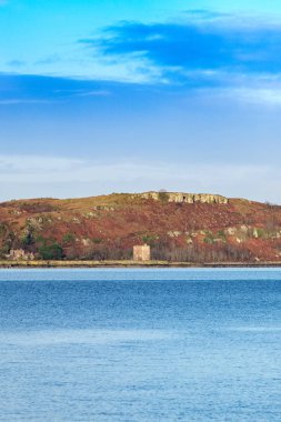 Little Cumbrae from Portencross at Seamill in Scotland where autumn colours can still be seen on the Island clipart