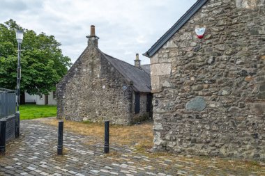 Irvine, Scotland, UK - July 12, 2020: Looking along Glasgow vennel Irvine to the side of the old Heckling house or shop where Robert Work learned the trade of spinning flax in the 18th Century Scotland. clipart