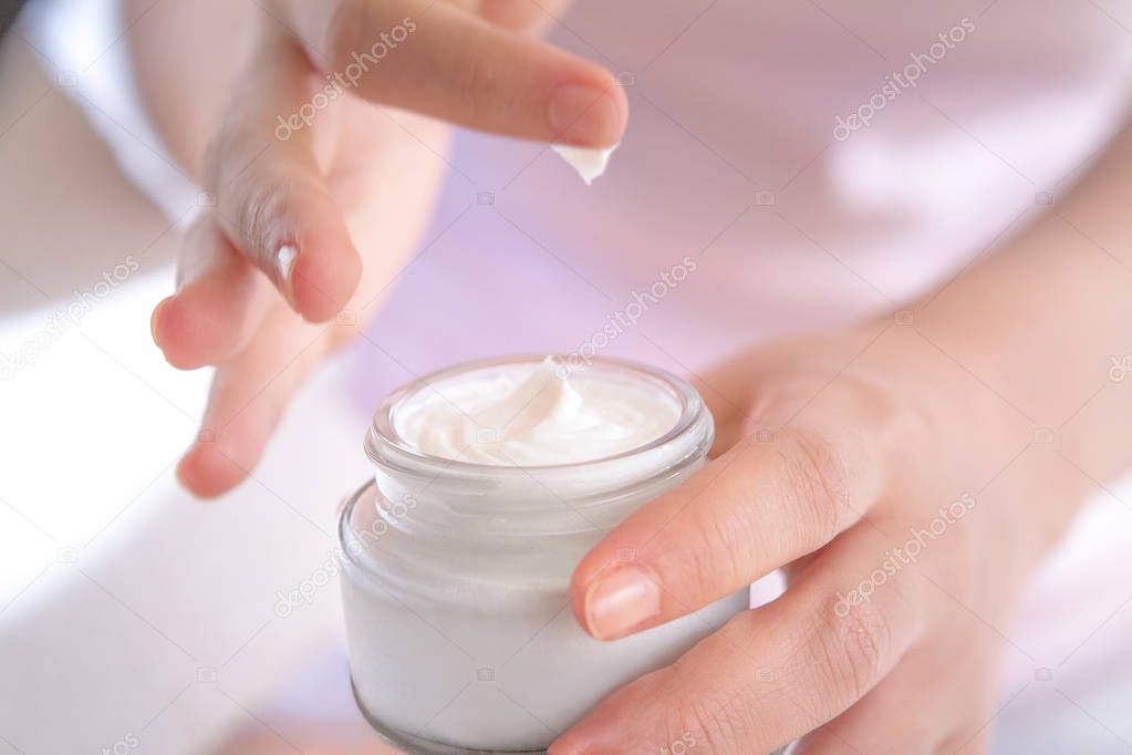the tip of cream mountain was sticked with the woman finger when she pick it up for applying
