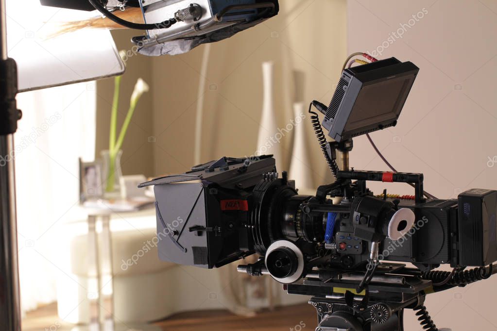 a studio lighting equipment is set over cinema camera and camera is ready for shooting