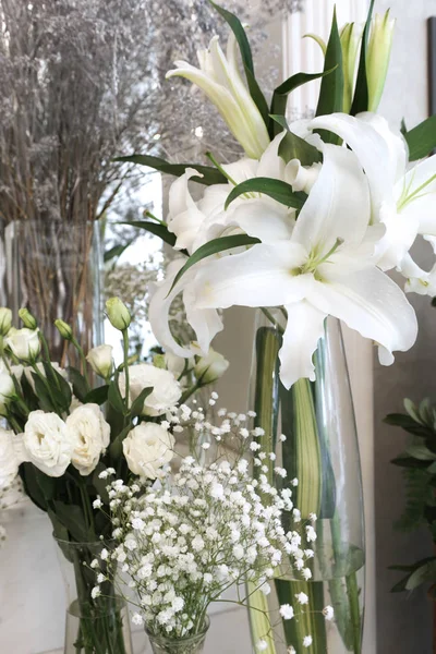 Glass vases of variety white flowers — Stock Photo, Image