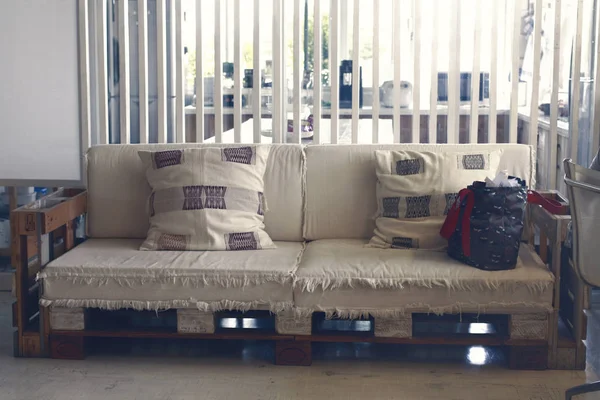 pallet sofa in front of partition