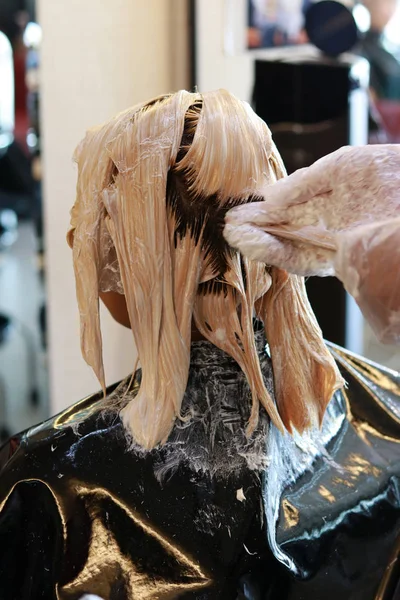 hair bleaching in back view portrait