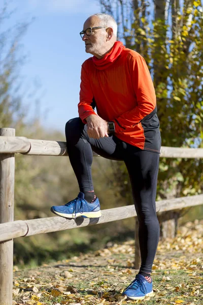 Full length Runner in red sportswear standing