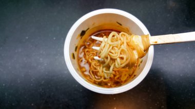 birisi plastik çatal tutan anlık erişte yemek için 