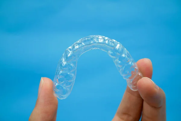 Hand holding clear plastic retainer teeth — Stock Photo, Image