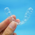 Hand holding clear plastic retainer teeth Stock Photo by ©Bhubeth ...