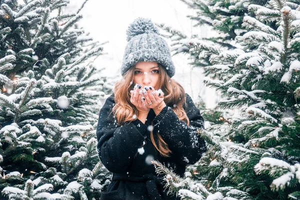 Beautiful russian girl in a cloud day in winter style clothes, walking in Tverskaya Square in Christmas time