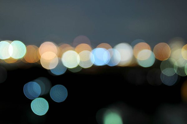 Abstract background of Colorful defocused bokeh lights in blur night background