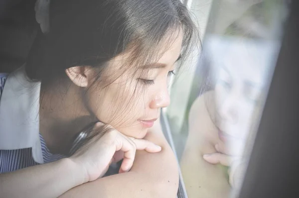 İyi günler! Sabah ve pencere oturmak ve hayal ederken bir mutluluk sahip genç akıllı başarılı gülümseyen kadın kapatmak.