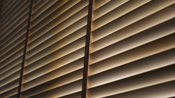 Evening sun light outside wooden window blinds, sunshine and shadow on window blind and, decorative interior home concept