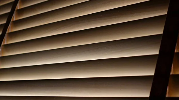 Evening sun light outside wooden window blinds, sunshine and shadow on window blind and, decorative interior home concept