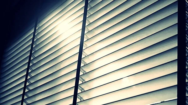 Evening sun light outside wooden window blinds, sunshine and shadow on window blind and, decorative interior home concept