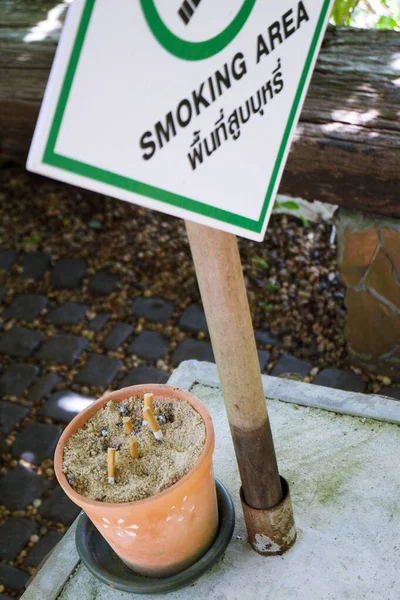 Designated smoking area sign on a board in front of the restaurant entrance. Designated smoking area sign on a board