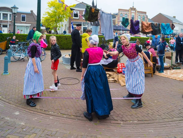 Urk 2018年5月19日 在传统服装中 不知名的女孩在 Urkerdays 上玩老式的弦游戏 Urk 是最著名的渔村在国家与最大的捕鱼舰队 — 图库照片