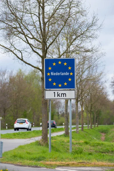 official blue eu sign with the name of the netherlands when crossing the border from germany