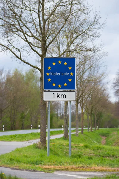 official blue eu sign with the name of the netherlands when crossing the border from germany