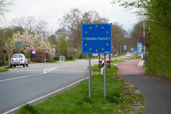 official blue eu sign with the name of the netherlands when crossing the border from germany