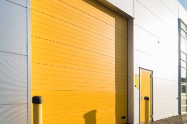 small industrial unit with yellow roller doors clipart