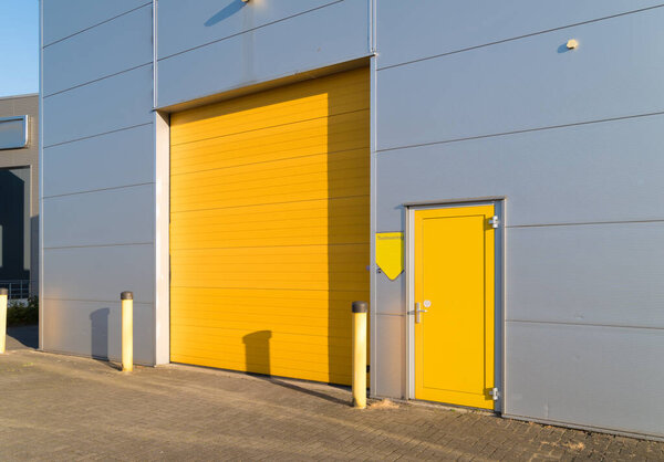 small industrial unit with yellow roller doors