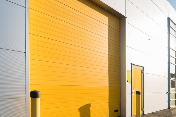 small industrial unit with yellow roller doors