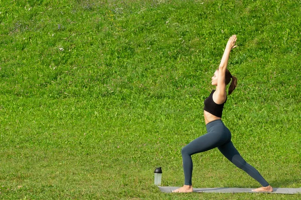 Woman on a yoga, relax in the park.