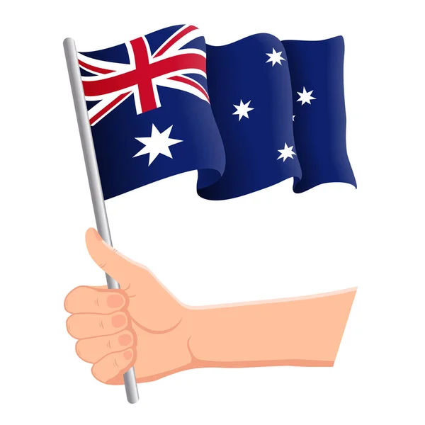 Hand haltend und die australische Nationalflagge schwenkend. Fans, Unabhängigkeitstag, patriotisches Konzept. Vektorillustration — Stockvektor