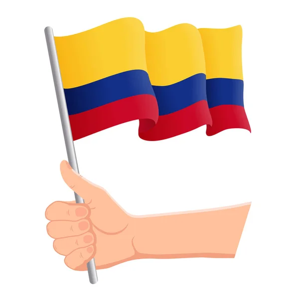 Mano sosteniendo y agitando la bandera nacional de Colombia. Aficionados, día de la independencia, concepto patriótico. Ilustración vectorial — Archivo Imágenes Vectoriales