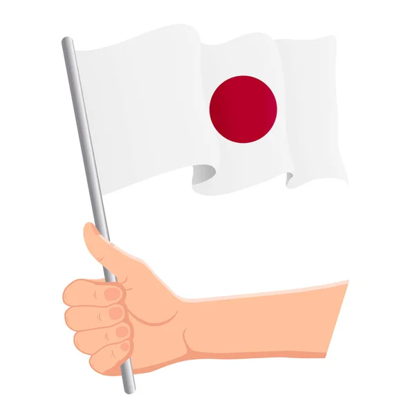 Mano sosteniendo y ondeando la bandera nacional de Japón. Aficionados, día de la independencia, concepto patriótico. Ilustración vectorial — Archivo Imágenes Vectoriales