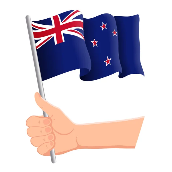 Hand holding and waving the national flag of New Zealand. Fans, independence day, patriotic concept. Vector illustration — Stock Vector