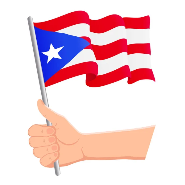 Hand haltend und die Nationalflagge von Puerto Rico schwenkend. Fans, Unabhängigkeitstag, patriotisches Konzept. Vektorillustration — Stockvektor