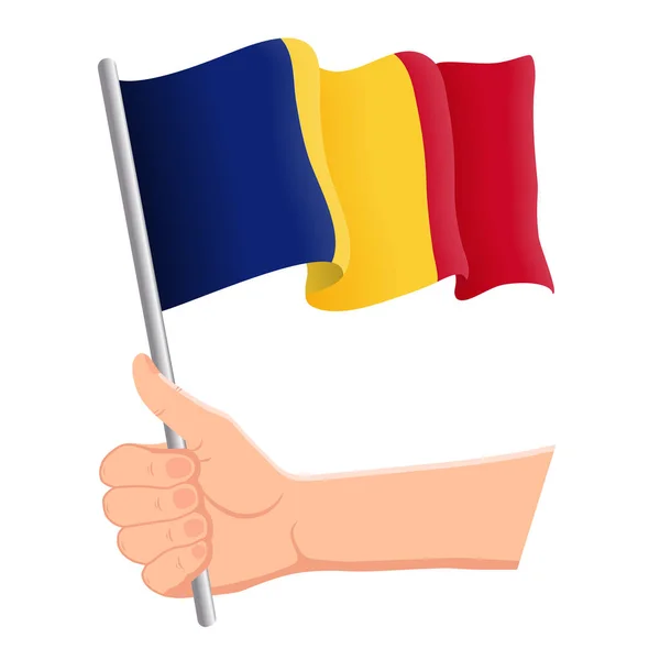 Mano sosteniendo y ondeando la bandera nacional de Rumania. Aficionados, día de la independencia, concepto patriótico. Ilustración vectorial — Vector de stock