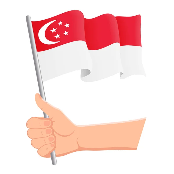 Mano sosteniendo y ondeando la bandera nacional de Singapur. Aficionados, día de la independencia, concepto patriótico. Ilustración vectorial — Archivo Imágenes Vectoriales