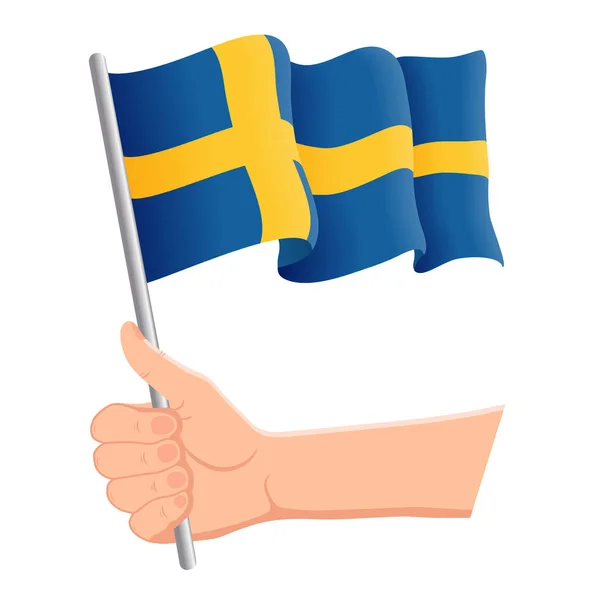 Hand houden en zwaaien de nationale vlag van Zweden. Fans, Independence Day, patriottische concept. Vector illustratie — Stockvector