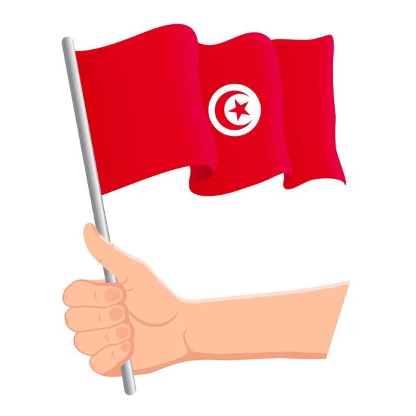 Hand holding and waving the national flag of Tunisia. Fans, independence day, patriotic concept. Vector illustration — Stock Vector